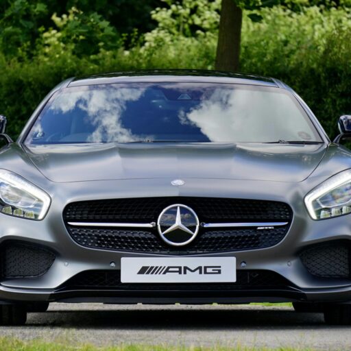 Front view of a luxury Mercedes-Benz AMG against a natural backdrop.